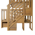 Close-up side view of a natural wood outdoor playset staircase and railing featuring diagonal slats, vertical posts, and paneling
