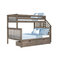 Gray wood twin-over-full bunk bed with built-in storage drawers, staircase and slatted rails, styled with light blue bedding