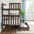 Solid dark wood bunk bed with pull-out trundle and storage drawers in a bright kids' bedroom with blue curtains, patterned wallpaper, decorative pillows and potted plant