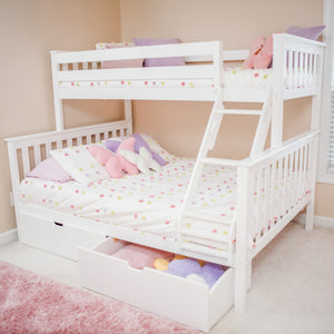 White wooden bunk bed with ladder and under-bed storage drawer in pastel pink children's bedroom, floral polka-dot bedding and plush pillows