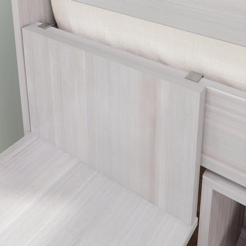 Close-up of whitewashed wood sliding cabinet door with brushed nickel top clips, textured fabric backing and modern minimalist hardware