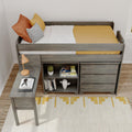 Twin loft bed with built-in desk and storage drawers in gray wood, mustard yellow bedding, orange and striped pillows, lamp, cactus and bookshelf — modern kids bedroom decor