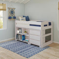 Kids loft bed with built-in storage shelves, blue geometric rug, coastal throw pillows and boho wall hanging