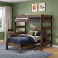 Dark walnut twin-over-twin bunk bed in kids' bedroom with green shiplap wall, navy bedding, study desk and framed sports artwork