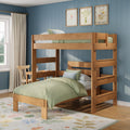 Wooden twin-over-twin bunk bed in a children's bedroom with green bedding, blue paneled wall, botanical wall art, study desk and floral rug