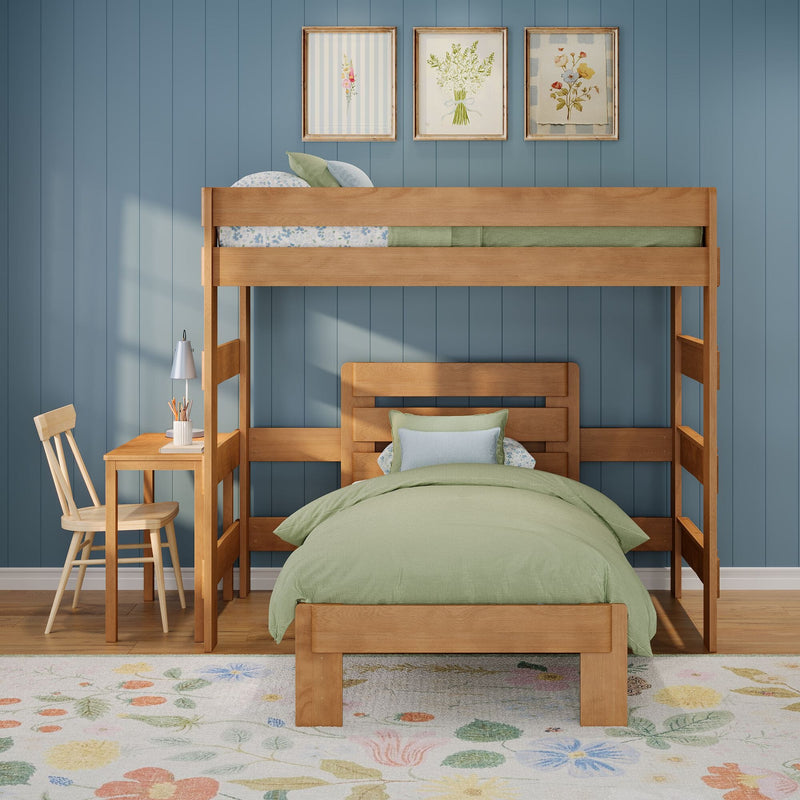Wooden bunk bed in a kids' bedroom with green bedding, blue paneled wall, small study desk and chair, floral rug and framed botanical prints