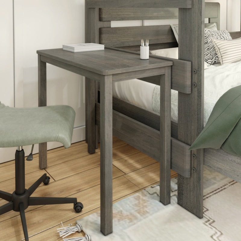 Compact gray wood bedside desk built into a bed frame, styled as a bedroom workspace with a book, pencil cup and rolling chair on hardwood floors