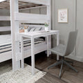 Space-saving whitewashed wooden bunk bed with built-in desk and striped bedding in a modern farmhouse kids bedroom featuring a gray swivel chair, potted plant, pencil holder, framed floral art and dark wood floors