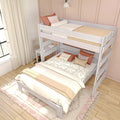 White wooden loft-style bunk bed in a kids' bedroom with study desk, neutral boho bedding, terracotta accent pillows, sheer curtains and hardwood floor