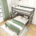 Rustic gray wooden bunk bed with sage green bedding, built-in desk and chair in a bright modern kids' bedroom