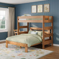 Natural wood bunk bed with sage green bedding in a kids bedroom against a blue vertical paneled wall, floral area rug, framed botanical prints and window with beige curtains