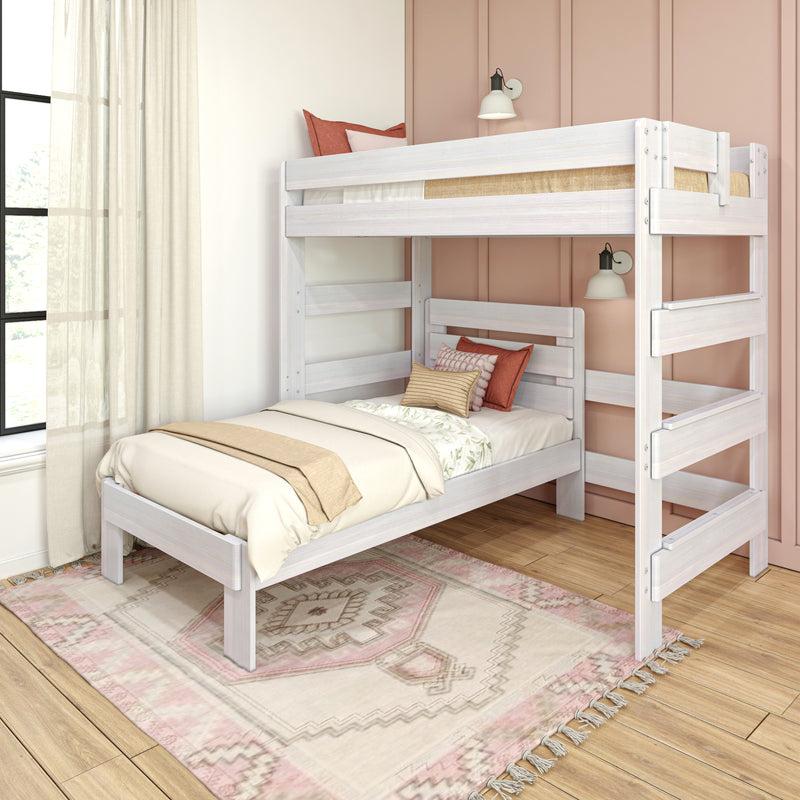 Whitewashed wooden bunk bed in bright kids' bedroom with pink paneled accent wall, cozy neutral bedding and boho rug