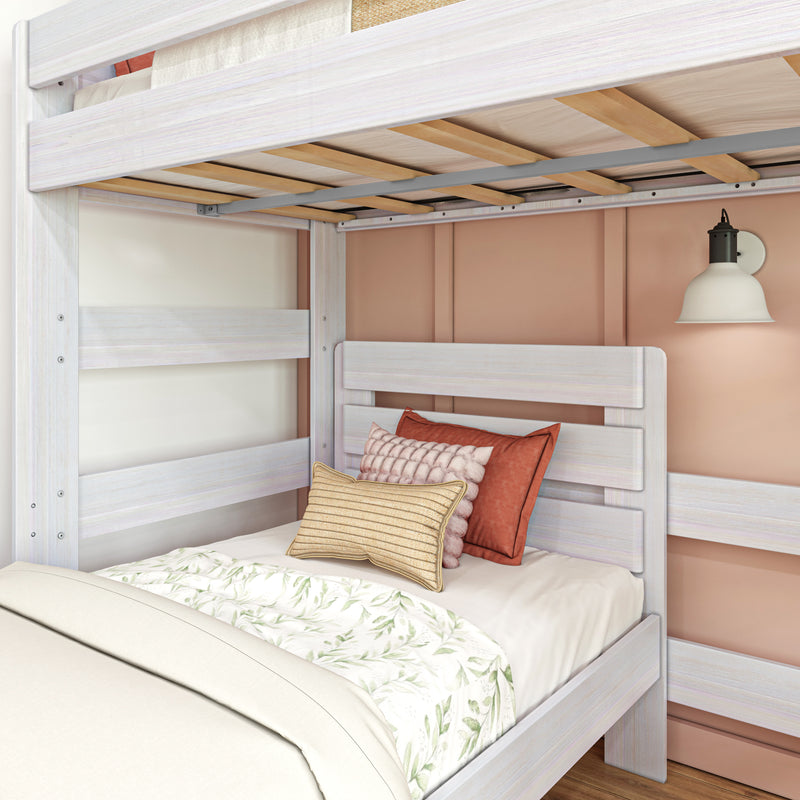 Whitewashed wooden twin bunk bed with exposed slats, floral bedding, textured pillows and wall sconce in cozy kids' bedroom