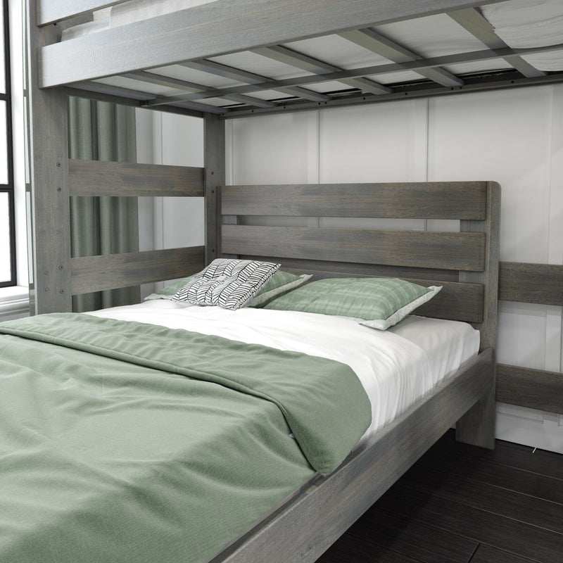 Gray wooden bunk bed with full-size lower bed, slatted headboard, green duvet and patterned accent pillow in modern farmhouse bedroom