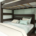 Close-up of a dark brown wooden bunk bed frame with slatted mattress support, beige bedding and mint decorative pillows