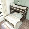 Wooden twin-over-full bunk bed with neutral bedding, decorative pillows and sheer curtains against a mint-green paneled wall — space-saving kids' bedroom design