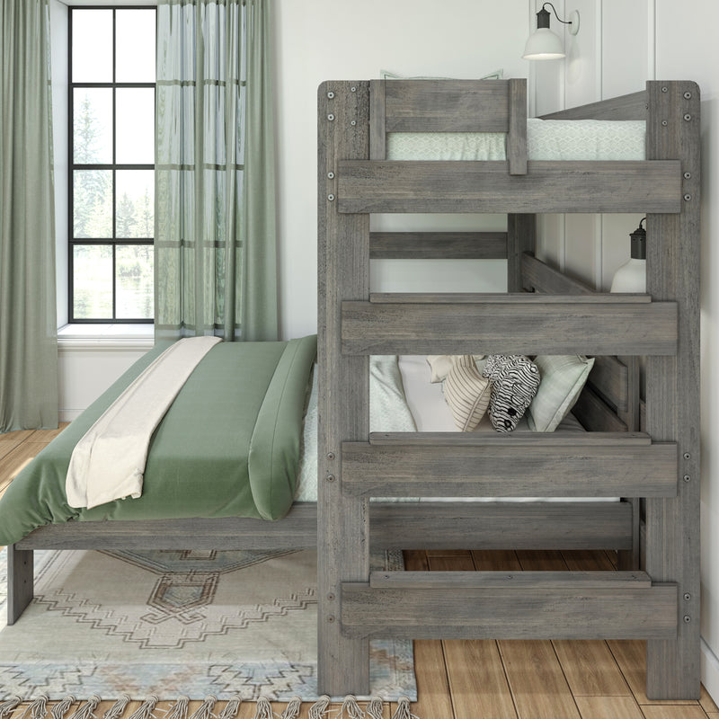 Rustic gray wooden bunk bed with sage green bedding and patterned pillows in a bright modern farmhouse bedroom by a window with green curtains