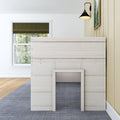Modern bedroom interior with whitewashed wood-panel headboard, olive-green Roman shade over grid window, black industrial wall sconce, beige vertical shiplap wall, light hardwood floor and blue textured area rug