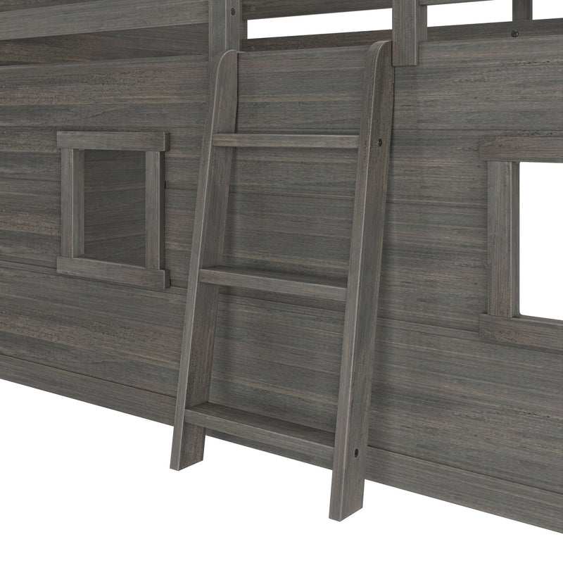 Gray wooden ladder attached to rustic bunk bed with wooden paneling and window cutouts.