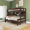 Dark walnut twin-over-full wooden bunk bed with built-in shelving, beige bedding and throw pillows in a green paneled bedroom with sheer curtains, plaid area rug and framed wall art