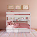 White wooden kids bunk bed with pink bedding, under-bed storage drawers and built-in shelving in a pastel girls bedroom with plaid rug and framed horse wall art