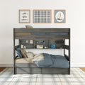 Modern gray wooden bunk bed with built-in shelves and under-bed drawers, blue bedding, plaid rug and nautical wall art in kids' bedroom