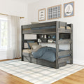 Gray rustic wooden twin-over-full bunk bed with built-in shelves and under-bed drawers in a bright modern kids' bedroom with blue bedding, plaid area rug, and nautical wall art