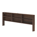 Dark walnut bookcase headboard with built-in shelves and cubbies for bedroom storage