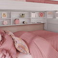 Cozy pink bedroom with soft pink duvet and plaid pillows under a white loft bed with built-in shelves displaying a pink alarm clock, retro camera, headphones and books