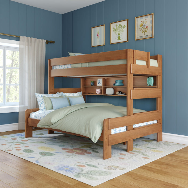 Twin-over-full wooden bunk bed with built-in shelves in a blue-paneled kids' bedroom, mint bedding, floral area rug and window with natural light