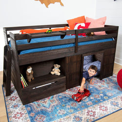 Dark wood kids loft bed with ladder, built-in storage drawers and playhouse cubby, blue bedding, colorful rug and child playing with red toy car