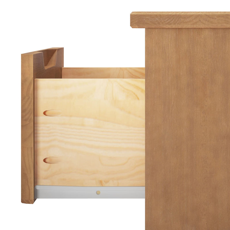 Open light-wood dresser drawer showing plywood side panels, visible wood grain, dovetail joint and metal drawer glide