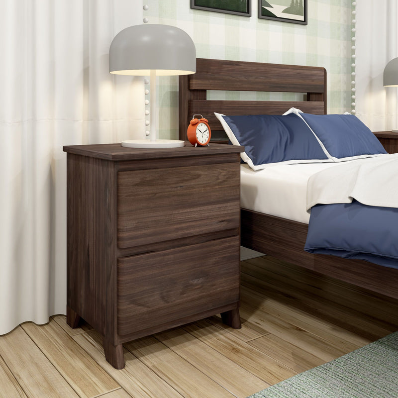 Modern bedroom with wooden nightstand, decorative lamp, and cozy bedding.