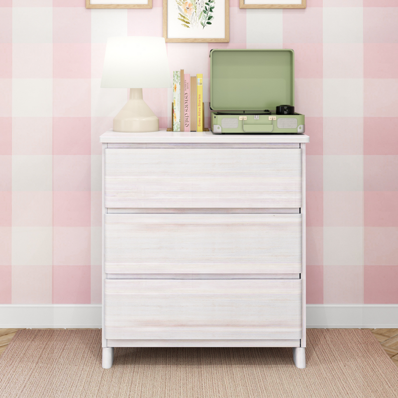 White dresser with lamp, books, and a green record player in a pink and white checkered room.