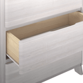 Whitewashed wooden dresser with open drawer revealing natural pine interior — modern Scandinavian bedroom storage nightstand