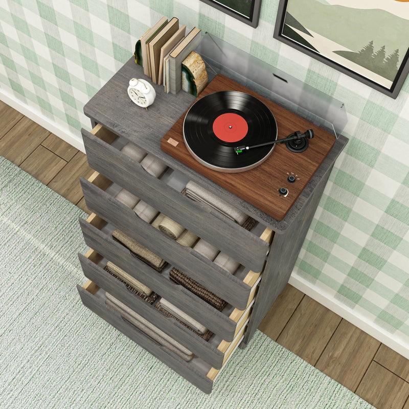 Vinyl record player turntable on a walnut top of a gray wooden dresser with open drawers filled with folded linens, mint green gingham wallpaper, hardwood floor and textured area rug, modern farmhouse bedroom decor