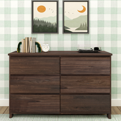 Dark walnut six-drawer dresser styled with agate bookends and books, white alarm clock and vinyl record player against green gingham wallpaper and framed landscape prints, modern bedroom storage and decor