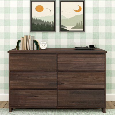 Dark wood dresser styled with books and agate bookend, white alarm clock and turntable beneath framed mountain landscape prints on green plaid wallpaper — modern farmhouse home decor