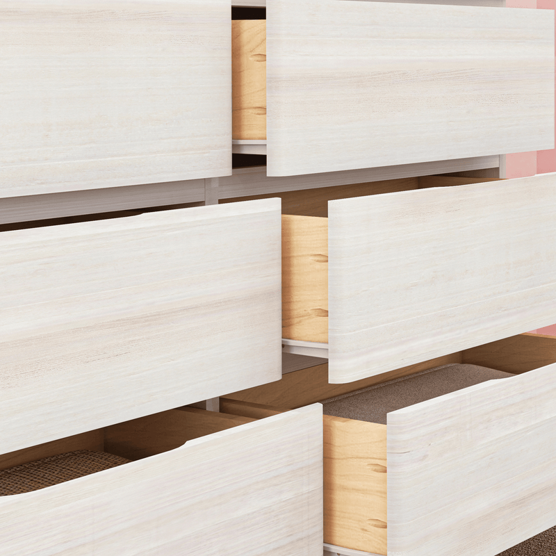Close-up of a light wood dresser with multiple partially open drawers — modern minimalist bedroom storage chest, Scandinavian-style natural wood grain
