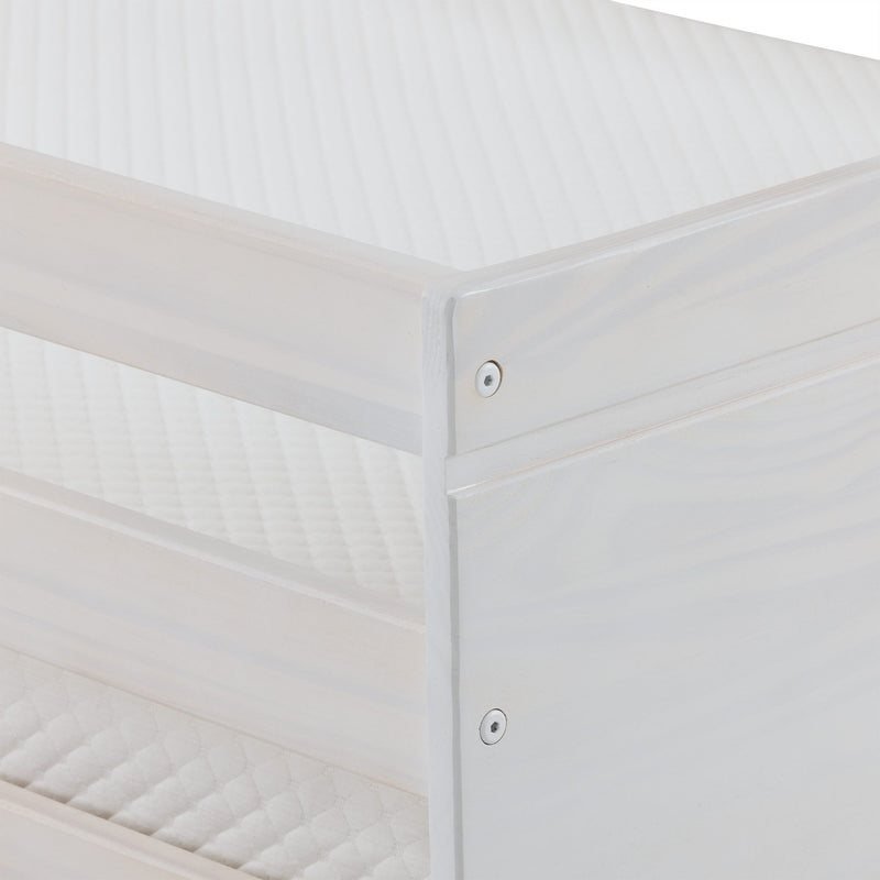 Close-up of white wooden bed frame corner with visible screw and quilted mattress cover