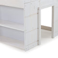 Close-up of white painted wooden bunk bed frame with built-in shelves, ladder opening and visible screw hardware