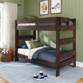 Dark wood twin bunk bed in kids bedroom with green paneled wall, navy bedding, sports wall art and wicker ball basket