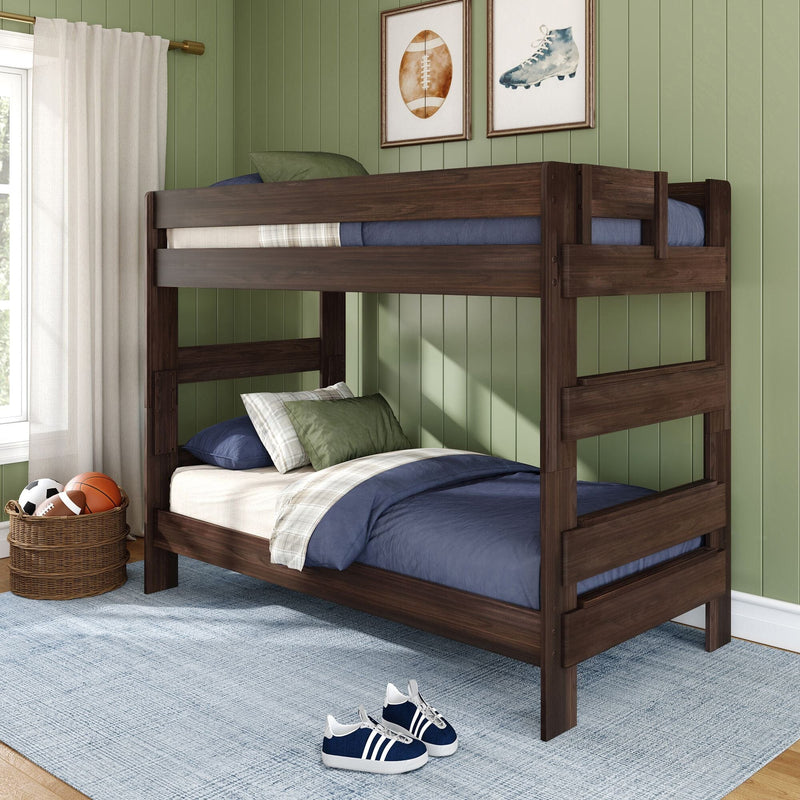Dark wood twin bunk bed in kids bedroom with green paneled wall, navy bedding, sports wall art and wicker ball basket