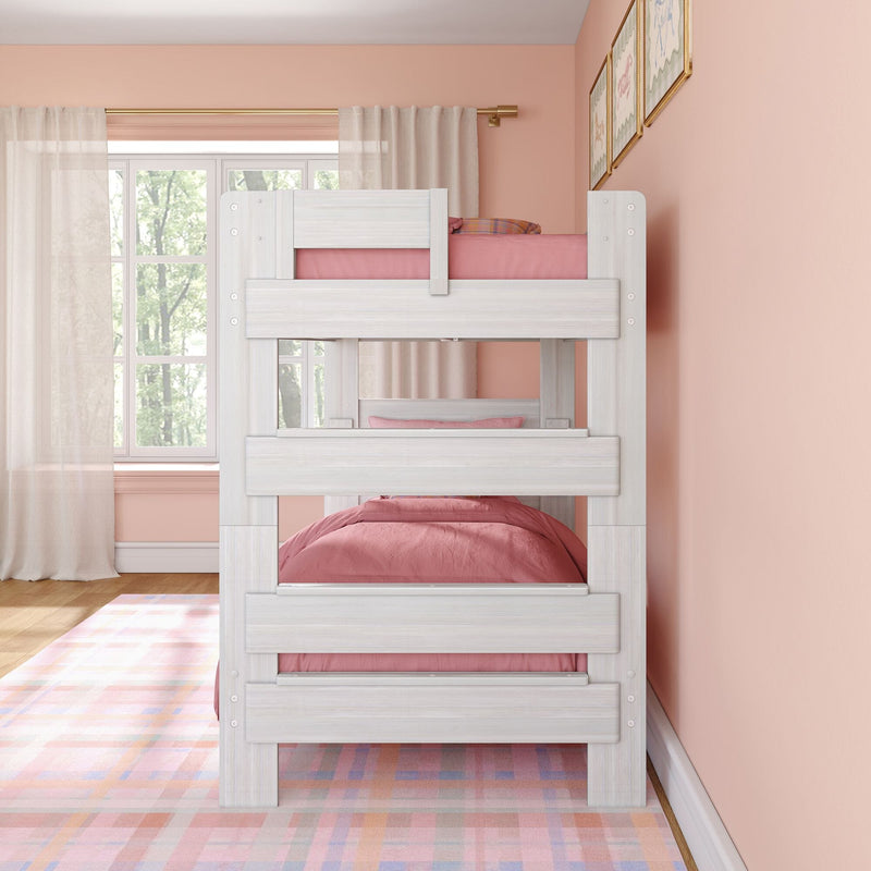 White wooden bunk bed with pink bedding in pastel girls' bedroom, sheer curtains, large window, framed wall art and colorful plaid rug