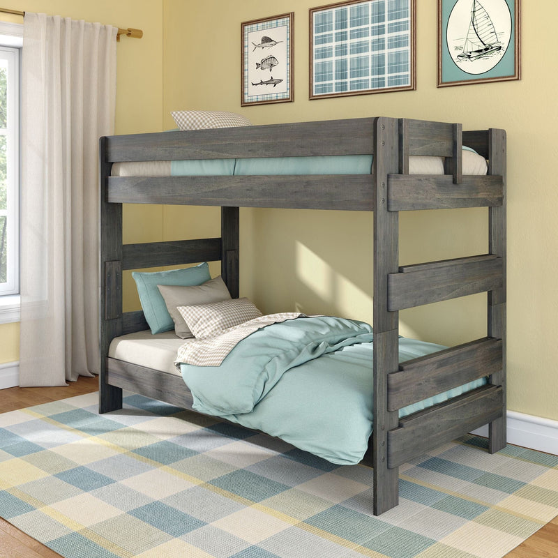 Gray wooden twin-over-twin bunk bed with teal bedding and pillows on a plaid rug in a coastal-themed kids bedroom with yellow walls, sheer curtains and framed boat art