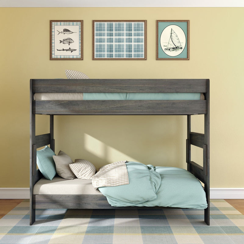 Wooden loft bunk bed with teal bedding, plaid rug and nautical framed art on yellow wall in kids' coastal bedroom