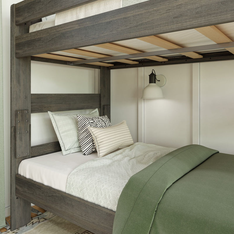 Gray reclaimed wood loft bunk bed with slatted plywood support, twin mattress, green duvet and striped accent pillows under a white wall sconce in a modern farmhouse bedroom