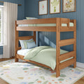 Natural wood bunk bed in a kids' bedroom with pastel green bedding, blue shiplap wall, floral rug, framed botanical prints and soft natural light