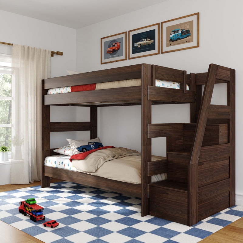 Dark walnut twin-over-twin wooden bunk bed with staircase storage in kids' bedroom, blue check rug, toy cars and framed car prints