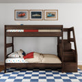 Dark wood twin-over-twin bunk bed with built-in staircase storage, car-themed bedding and car wall art in a kids' bedroom with blue checkered rug